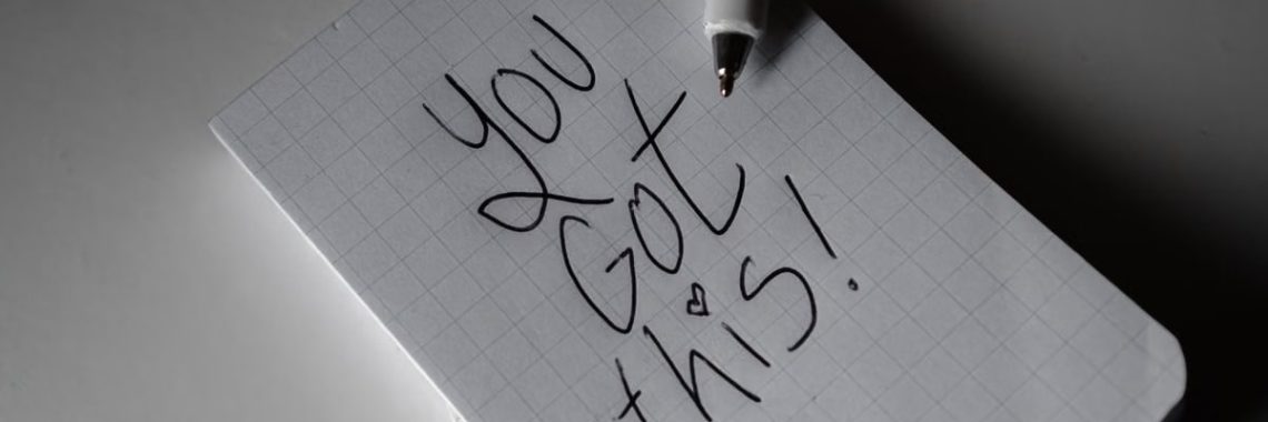 Inspirational handwritten note on graph paper with pen. Encouraging words 'You got this!'